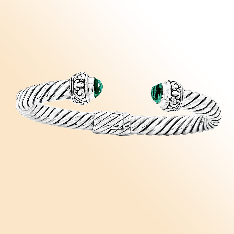 Handcrafted sterling silver cable cuff bracelet with green quartz and Balinese scroll details, elegant artisan jewelry for everyday wear.