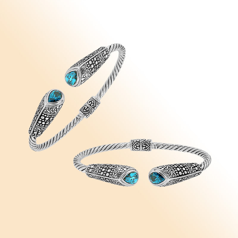 Elegant sterling silver open bangle with blue topaz quartz accents and Balinese dot design