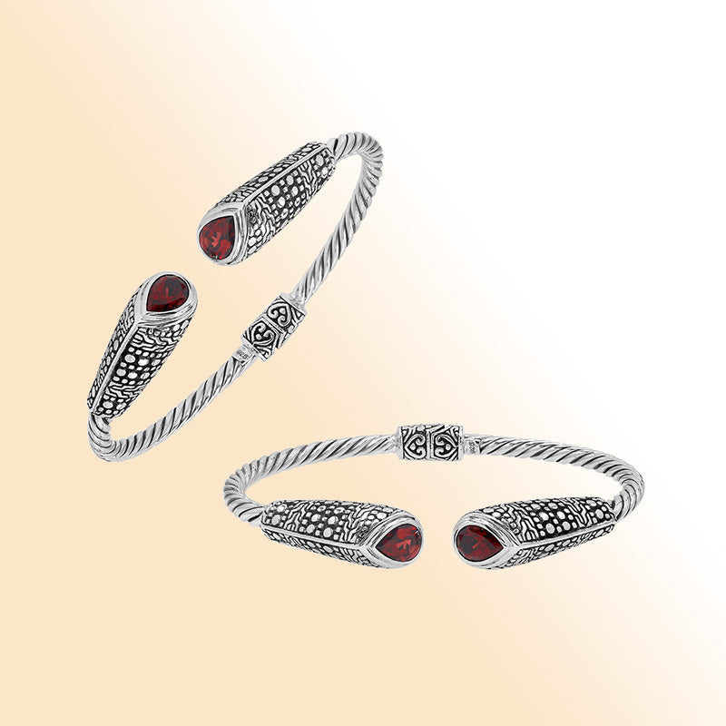 Elegant sterling silver open bangle with garnet quartz accents and Balinese dot design