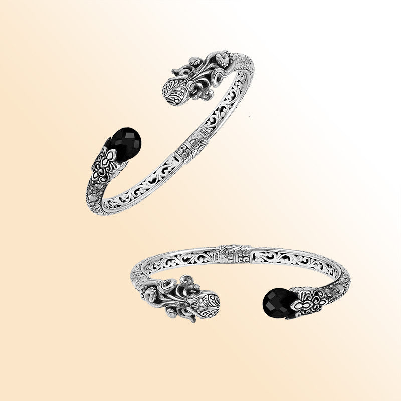 Handcrafted sterling silver dragon head cuff with black onyx ends and floral carvings made in Bali.
