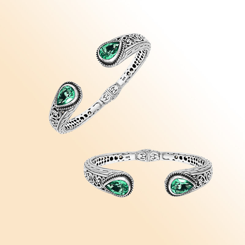 Sterling silver hinge-lock cuff bangle with green quartz teardrops and Balinese carved detailing.