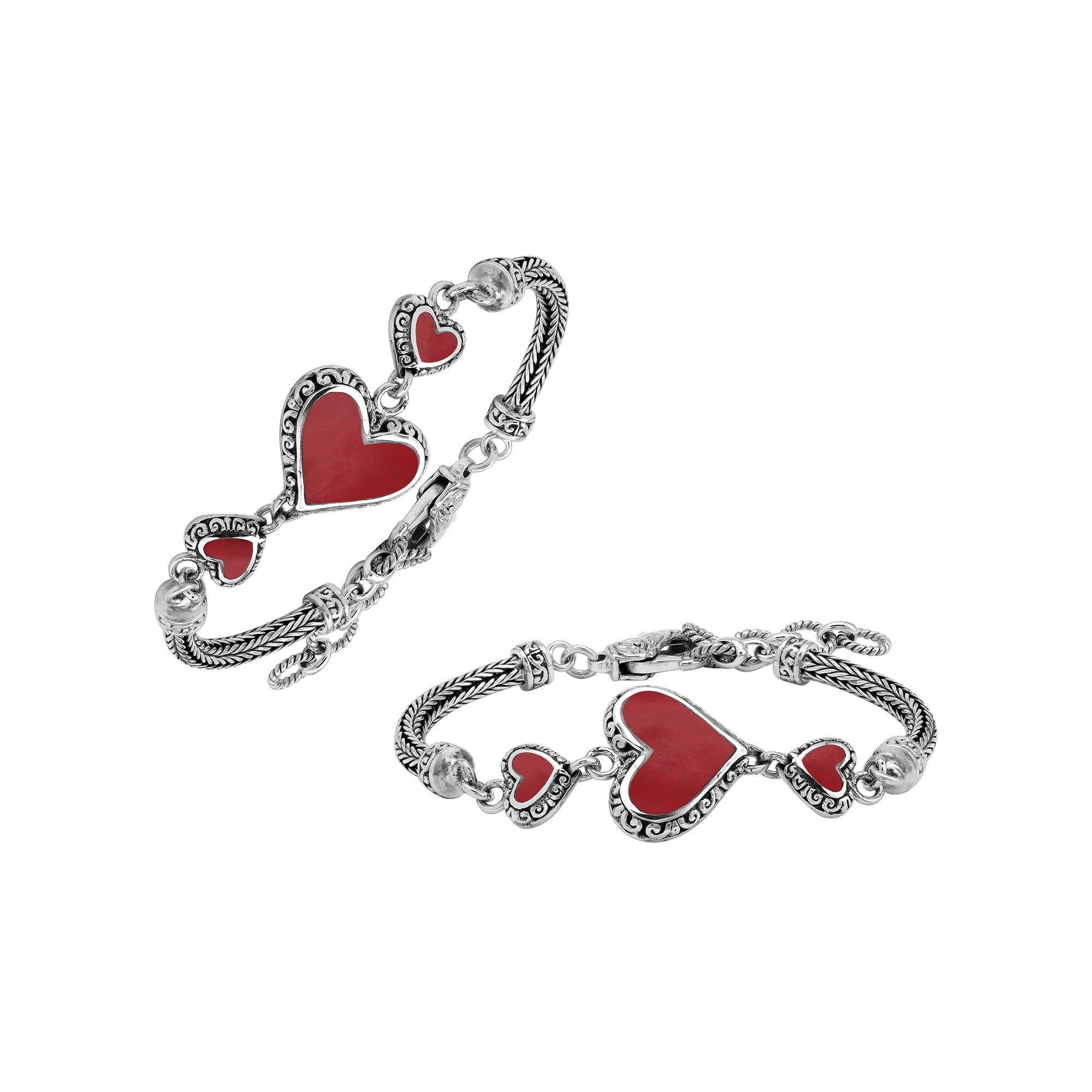 Handcrafted sterling silver bracelet featuring Red Coral heart motifs, ornate Balinese scroll engravings, and a secure lobster lock for colorful, expressive, artisan-style everyday wear.
