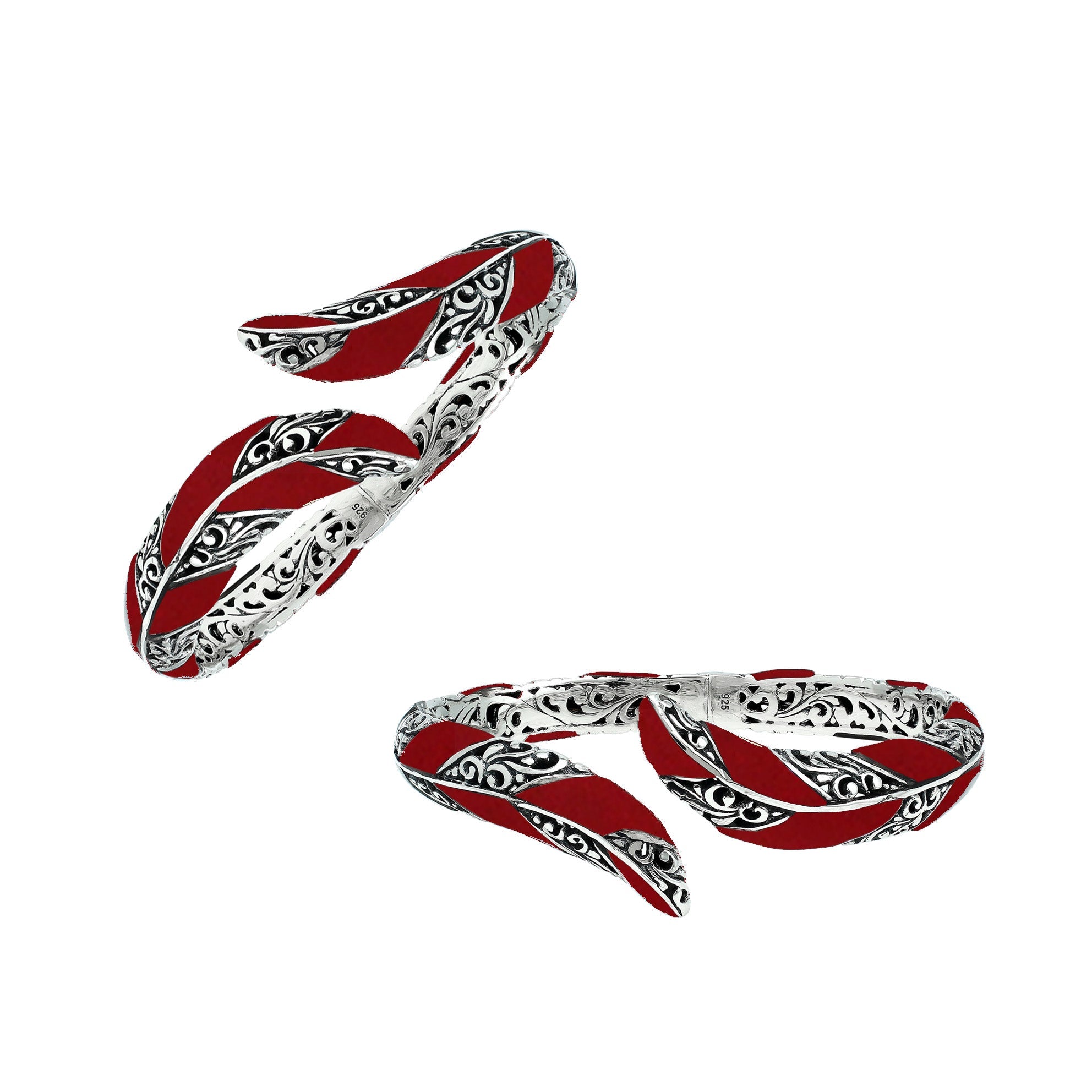 Handcrafted sterling silver feather-inspired bangle featuring vivid Red Coral inlays, ornate Balinese scroll engravings, and a secure hinge lock for expressive, artistic everyday elegance.