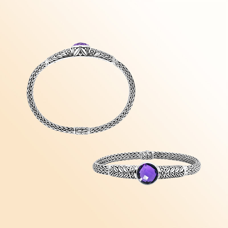 Handcrafted sterling silver woven chain bracelet with a brilliant Amethyst Quartz centerpiece, Balinese engraved detailing, and a secure push clasp for elegant daily wear.