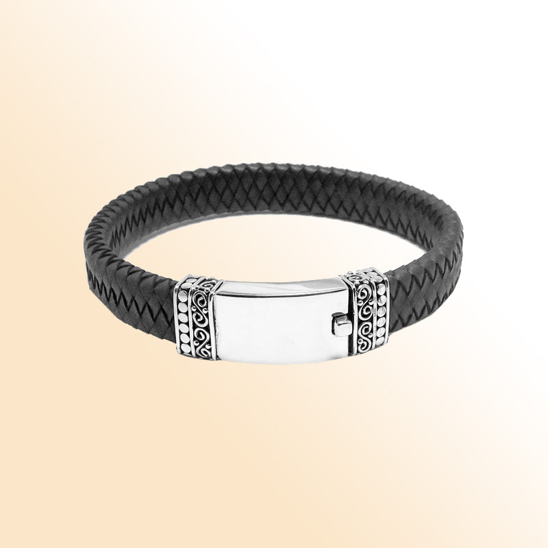 Handcrafted sterling silver and braided leather men’s bracelet featuring a polished central plate and a secure push clasp for refined everyday wear.