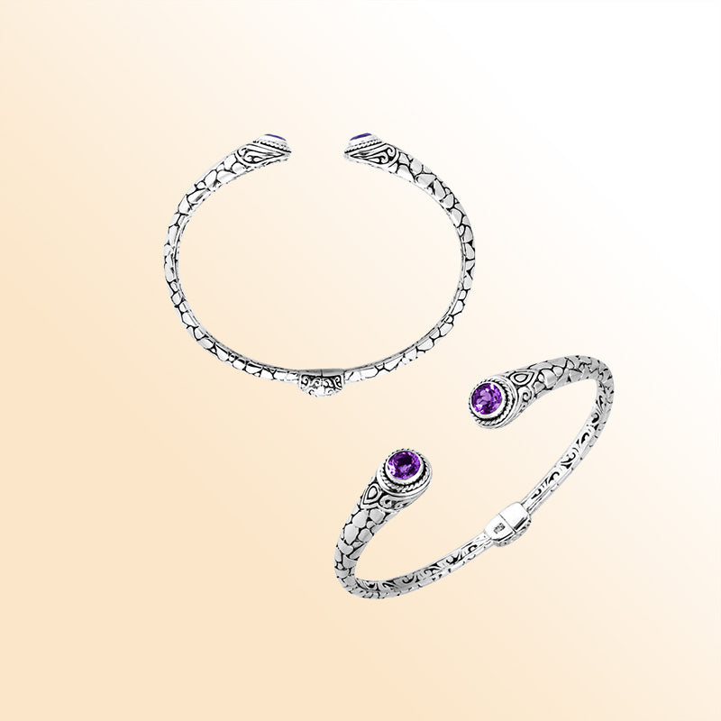Sterling silver Bali hinge cuff featuring polished–oxidized engravings and radiant amethyst quartz ends, crafted for individuals who appreciate expressive, artistic, and beautifully detailed jewelry.