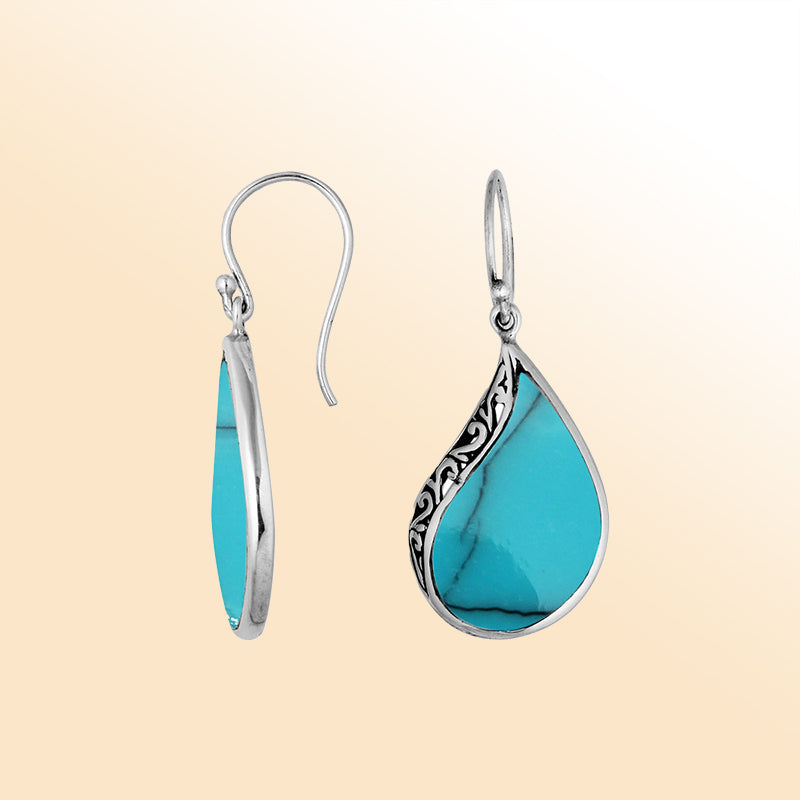 Handcrafted sterling silver teardrop drop earrings with vibrant turquoise inlay and Balinese scrollwork design