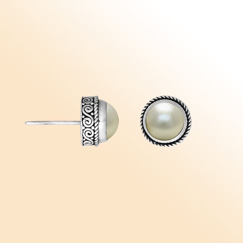 Silver stud earrings featuring natural White Pearls with ornate Bali scrollwork.