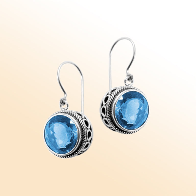 Sterling silver artisan earrings featuring Blue Quartz in an ornate halo with earwire lock.