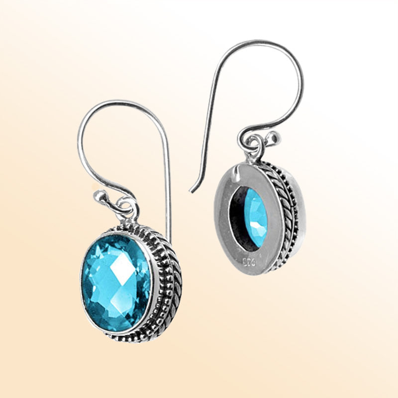 Sterling silver artisan earrings featuring Blue Topaz Quartz with detailed frame and earwire lock.