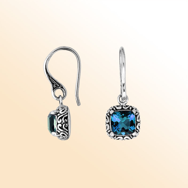 Handcrafted sterling silver London Blue Topaz Quartz cushion drop earrings with antique oxidized detailing and polished ocean blue tone.
