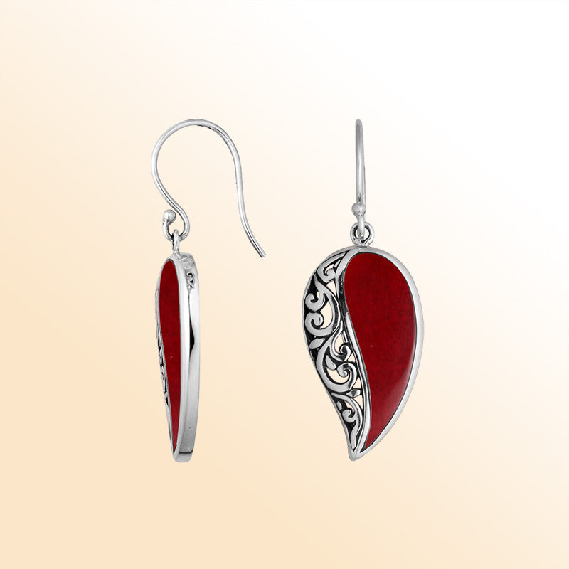 A stunning pair of 925 sterling silver earrings featuring teardrop Red Coral stones with detailed Balinese filigree design and secure earwire hooks for women.