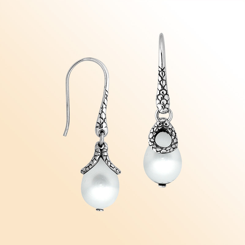 Sterling silver earrings with White Pearl teardrop design and polished silver detailing.