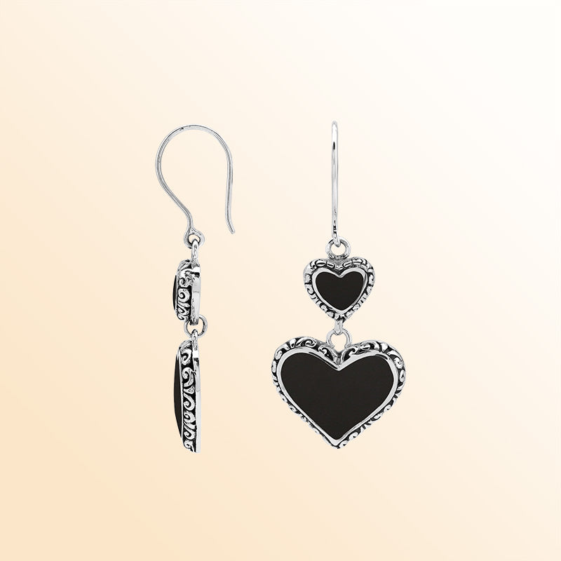 Sterling silver artisan earrings featuring deep-toned black shell double hearts with ornate borders, designed to create an expressive romantic look for elegant and stylish everyday wear.