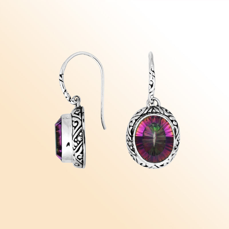 Sterling silver earrings featuring a vibrant oval Mystic Topaz Quartz stone with multicolor brilliance, framed in ornate carved detailing and finished with an earwire lock for radiant handcrafted everyday wear.