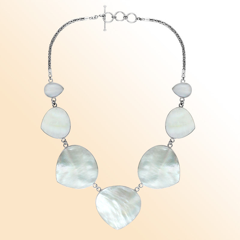 Women’s sterling silver necklace with heart-shape Mother of Pearl stones and Bali-inspired accents.
