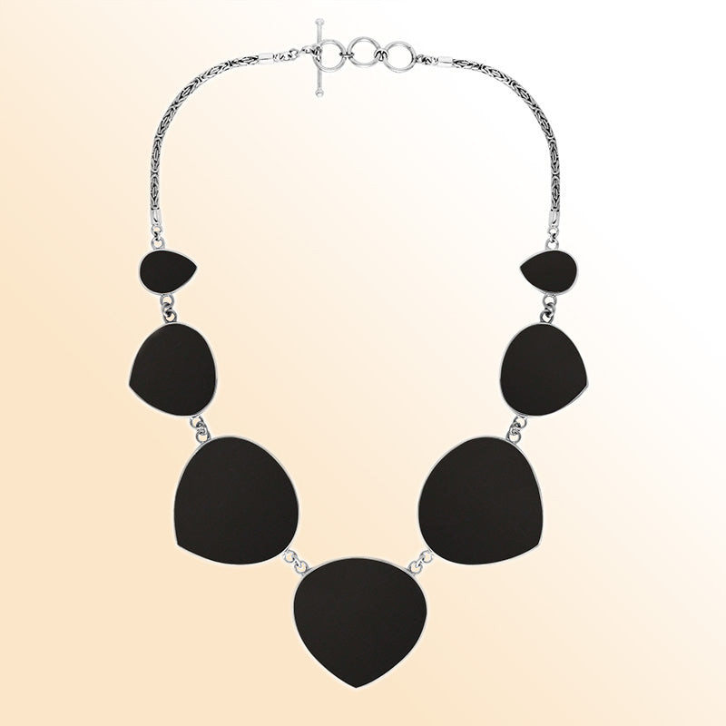 Women’s sterling silver necklace with heart-shape black shell stones and Bali-inspired accents.