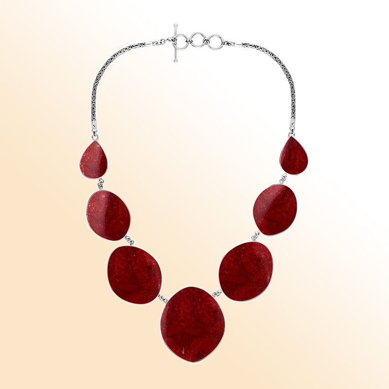 Women’s sterling silver necklace with oval and teardrop coral stones and Bali-inspired accents.
