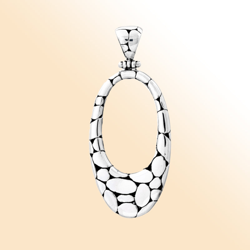Elegant sterling silver oval pendant with unique pebble texture, handcrafted Bali jewelry for everyday wear.