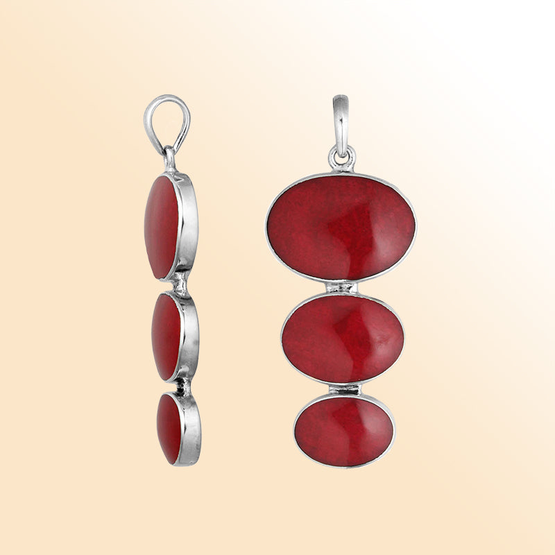 Handcrafted sterling silver pendant with three oval red coral stones, artisan Bali jewelry for elegant everyday wear.