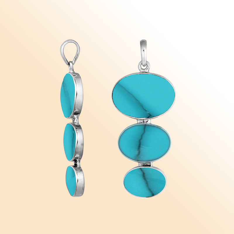 Handcrafted sterling silver pendant with three oval turquoise stones, vibrant blue-green artisan Bali jewelry.