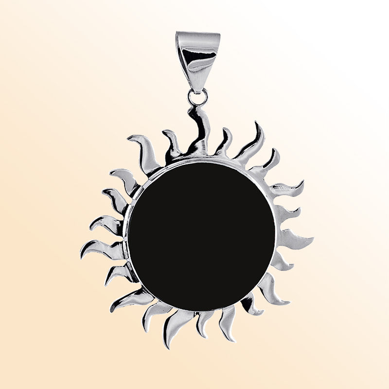 Handcrafted sterling silver sunburst pendant with polished black shell center, elegant Bali artisan jewelry.