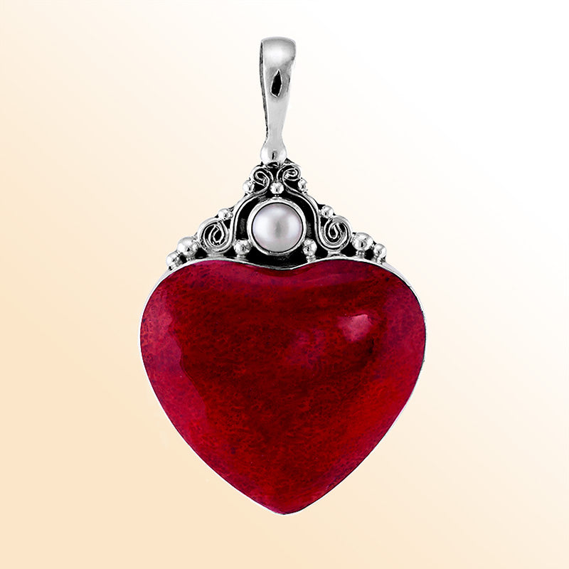 Handcrafted sterling silver heart pendant with vibrant red coral centerpiece and luminous Fresh Water Pearl accent, artisan Bali jewelry for timeless elegance.