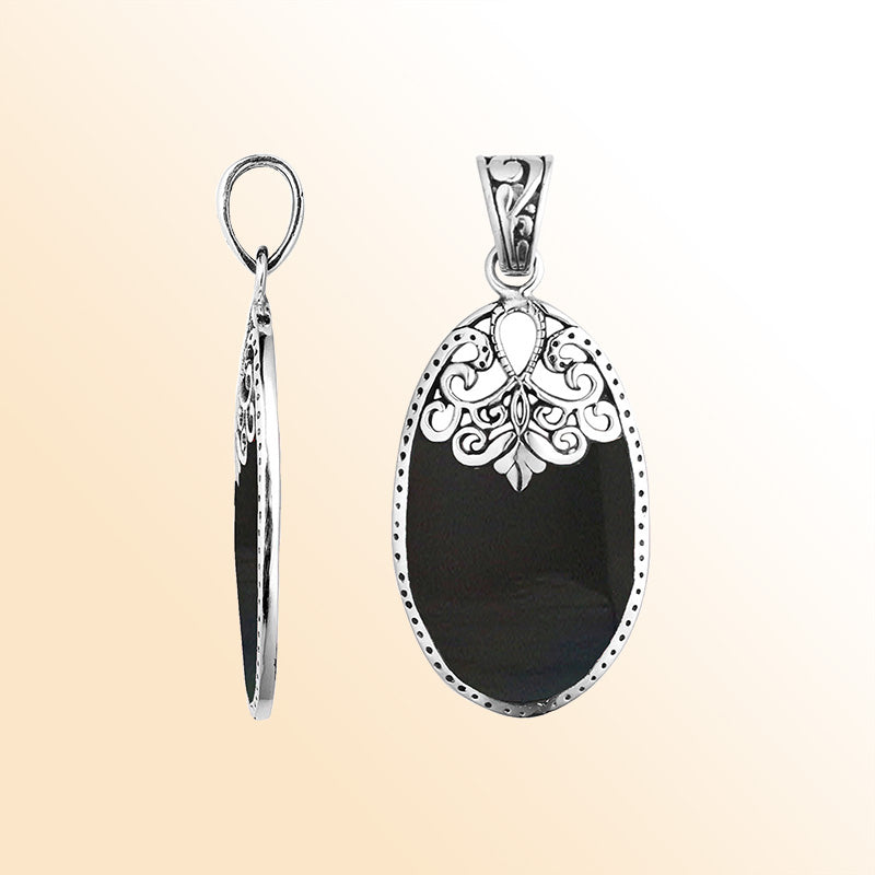 Sterling silver oval pendant with black shell inlay and delicate Balinese filigree design, handcrafted in Bali.
