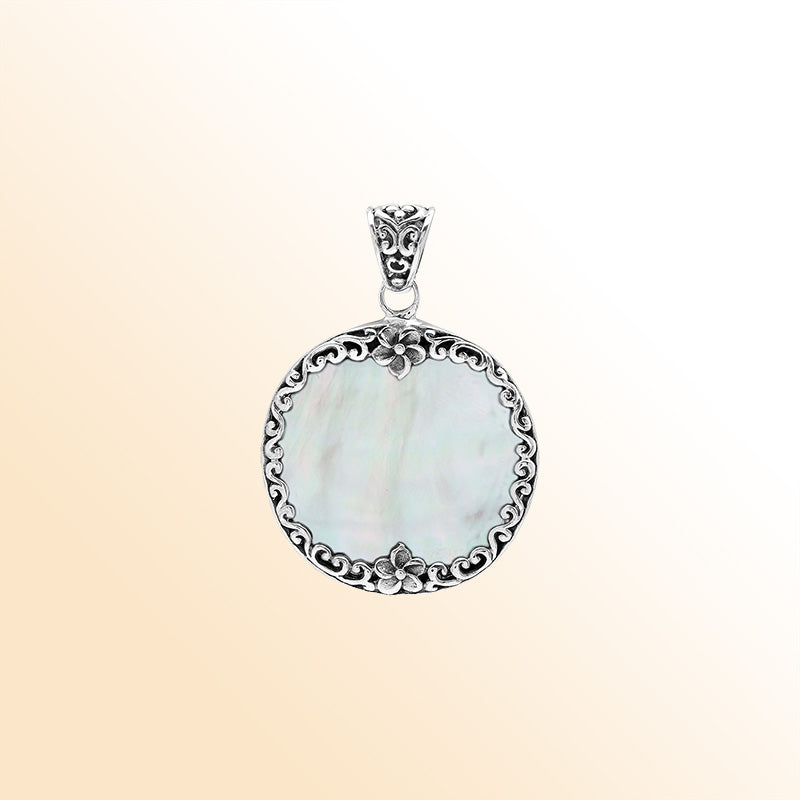 Sterling silver round pendant with luminous mother of pearl and floral Bali frame, handcrafted artisan jewelry for elegant everyday wear.