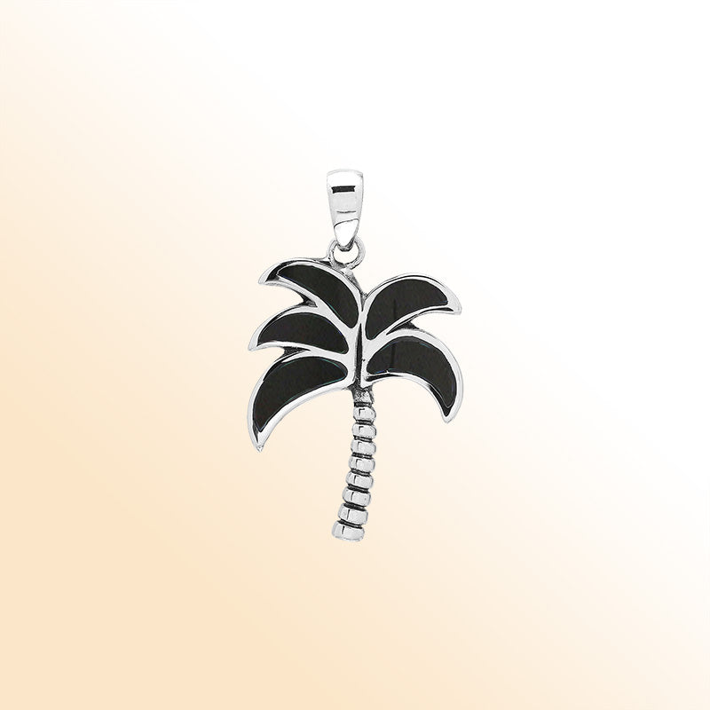 Sleek palm tree pendant in sterling silver with black shell inlay and textured trunk, artisan-crafted for modern tropical style.