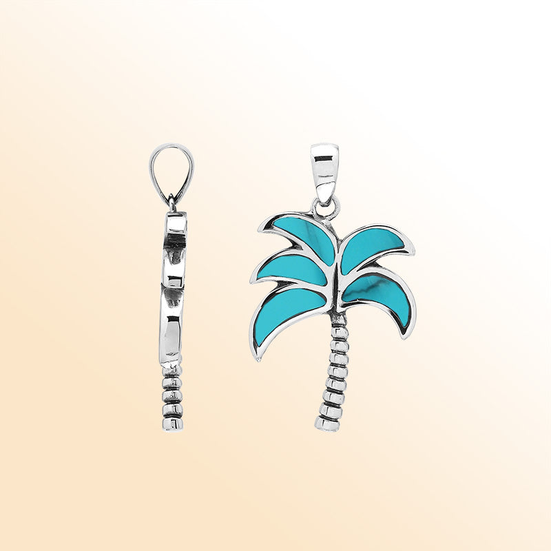 Vibrant sterling silver palm tree pendant with turquoise shell inlay and textured trunk, artisan-crafted for tropical beach style.