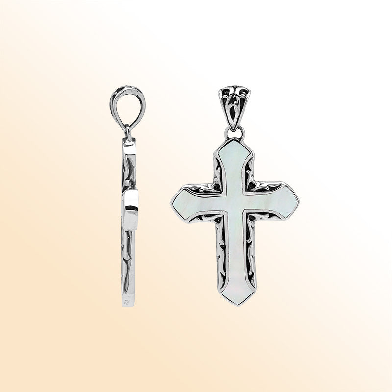 Mother of pearl cross pendant in sterling silver with handcrafted Balinese design, elegant religious jewelry.