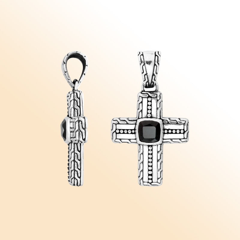 Silver cross pendant with black onyx stone in artistic design.