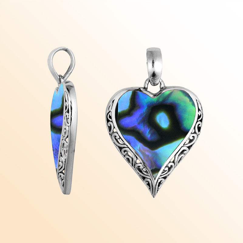 Sterling silver heart pendant with luminous Abalone Shell detailing, graceful artisan scrollwork, and ocean-inspired beauty for elegant everyday wear.