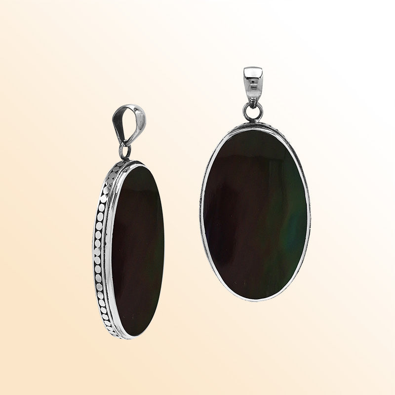 Sterling silver oval pendant with black shell and hammered silver frame handcrafted in Bali