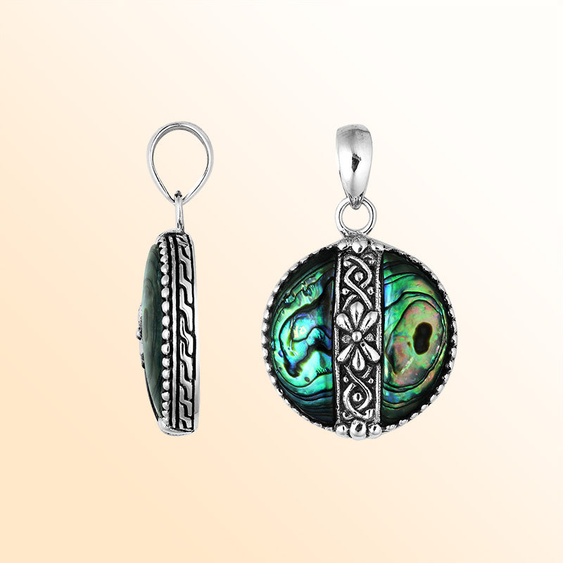 Elegant Sterling Silver Abalone Shell round pendant featuring floral center pattern, handcrafted mirror-polished finish, and iridescent blue-green hues for women’s artistic jewelry collections.