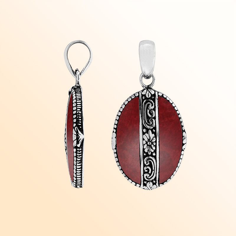 Elegant Sterling Silver Red Coral oval pendant featuring floral center design, handcrafted mirror-polished finish, and vibrant red tones for women’s artistic jewelry collections.