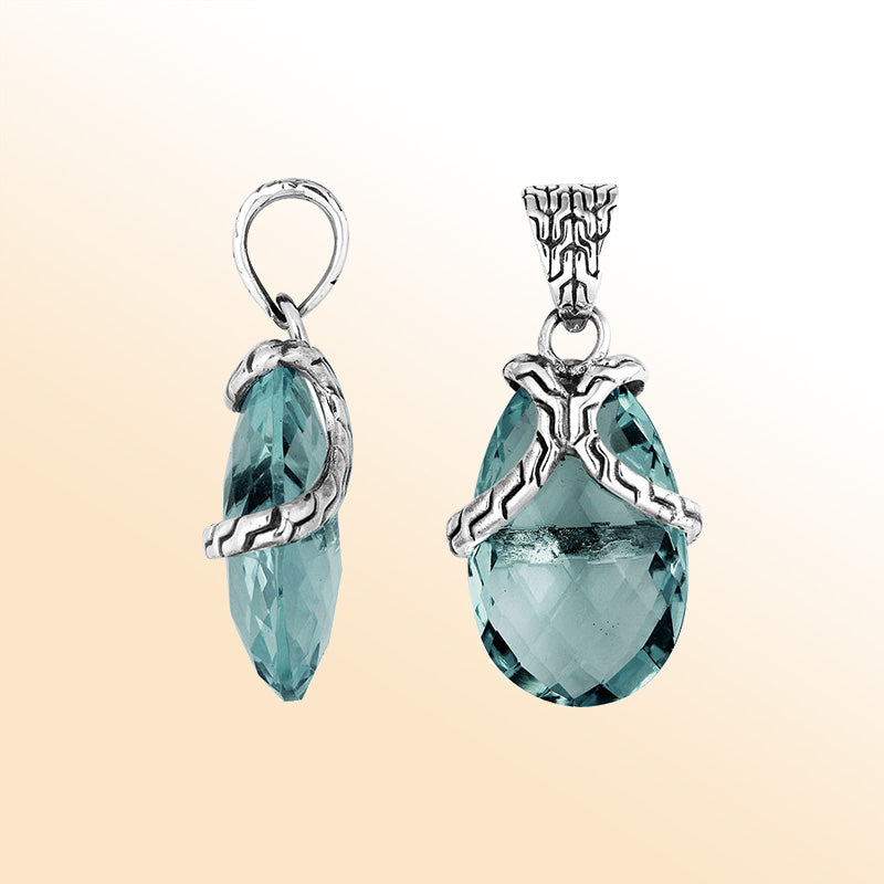 Elegant Sterling Silver London Blue Topaz Quartz pear pendant featuring textured bail design, handcrafted mirror-polished finish, and deep blue tone for women’s artistic jewelry collections.