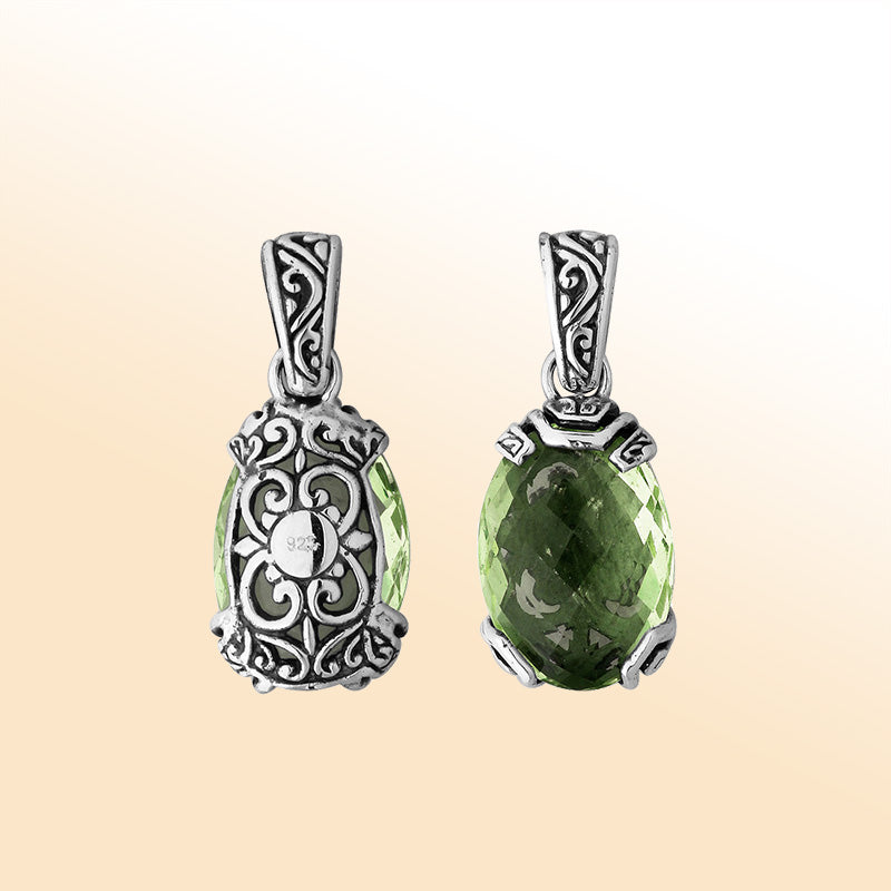 An elegant sterling silver pendant featuring a luminous Green Amethyst Quartz encased in intricate Balinese filigree, handcrafted with timeless elegance and detail.