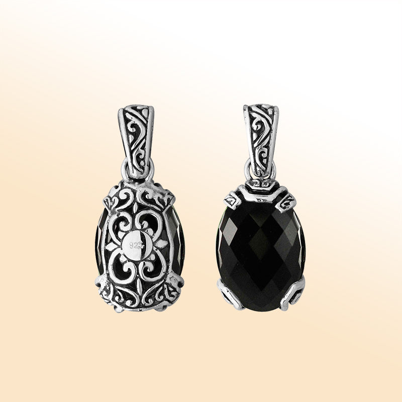 An elegant sterling silver pendant featuring a luminous Black Onyx stone set in intricate Balinese filigree, handcrafted with timeless artistry and refined elegance.