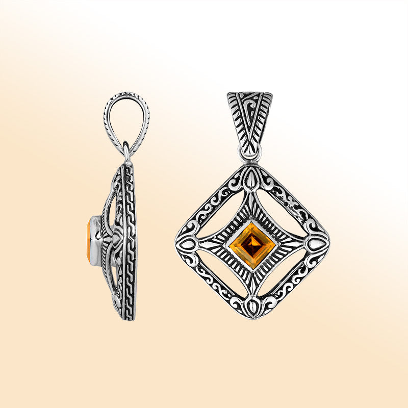 An elegant sterling silver pendant featuring a glowing Citrine Quartz in a handcrafted Balinese filigree frame, radiating artistry and timeless elegance.