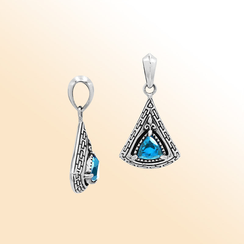 Handcrafted sterling silver triangular pendant with trillion-cut blue topaz quartz, geometric engravings, and high-gloss polished Balinese detailing.