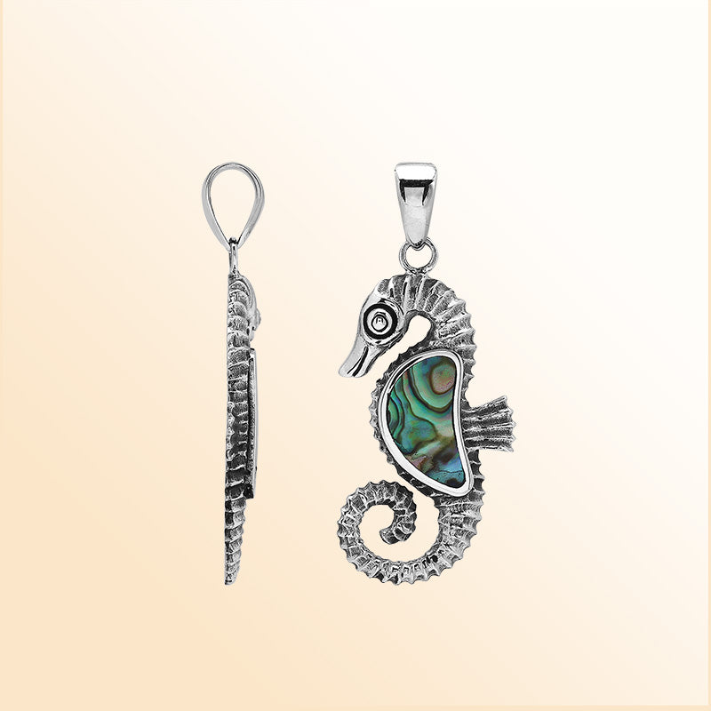 Handcrafted sterling silver seahorse pendant with Abalone Shell, polished surface, and artistic Balinese detailing.