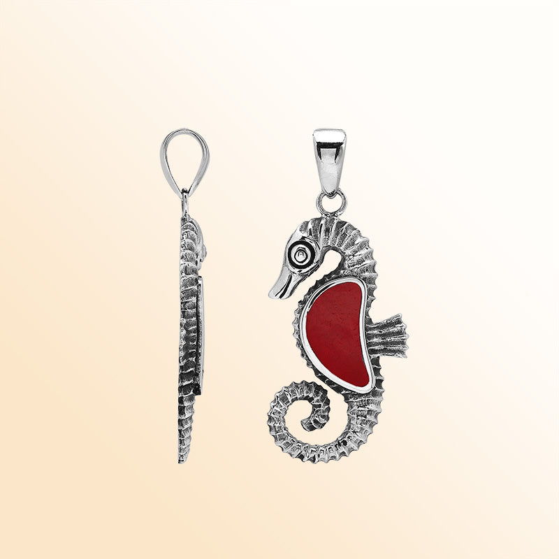 Handcrafted sterling silver seahorse pendant with vibrant Red Coral, polished surface, and artistic Balinese detailing.