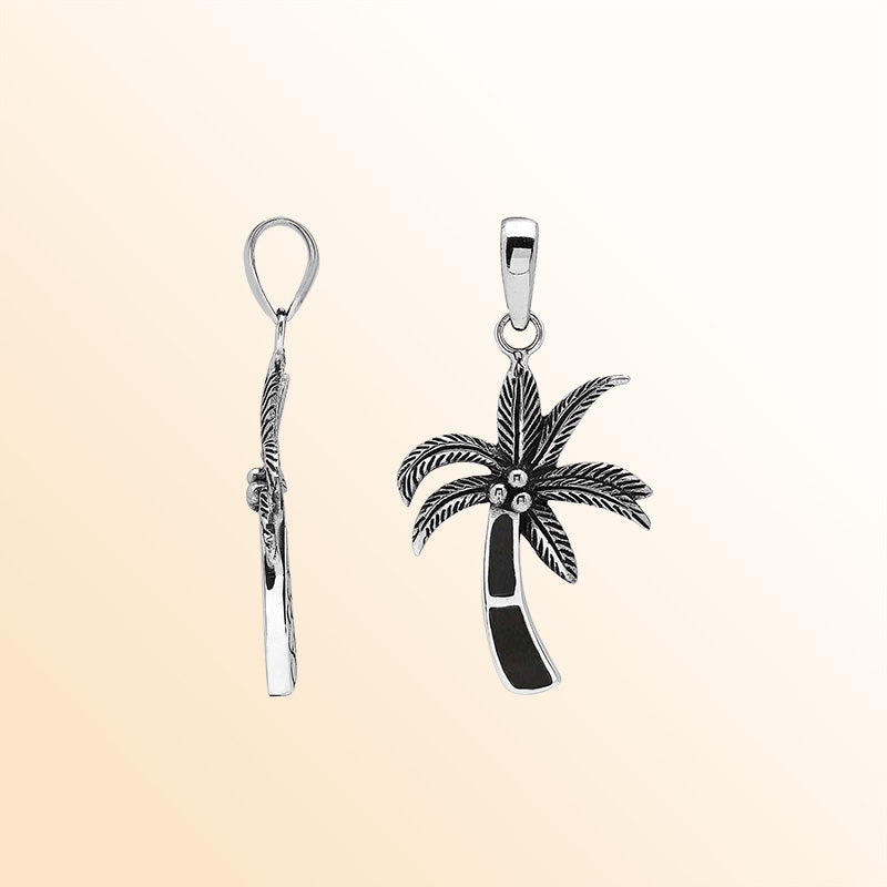 Elegant sterling silver palm tree pendant with black shell inlay and Balinese craftsmanship in a polished high-gloss finish.