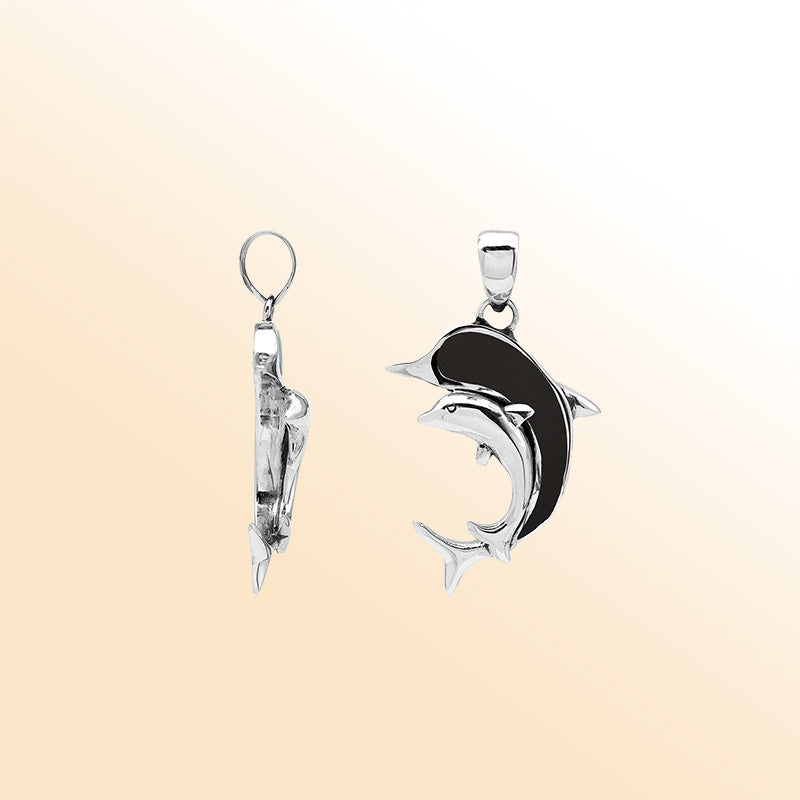Elegant sterling silver dolphin pendant with black shell inlay and Balinese craftsmanship in a polished ocean-inspired design.