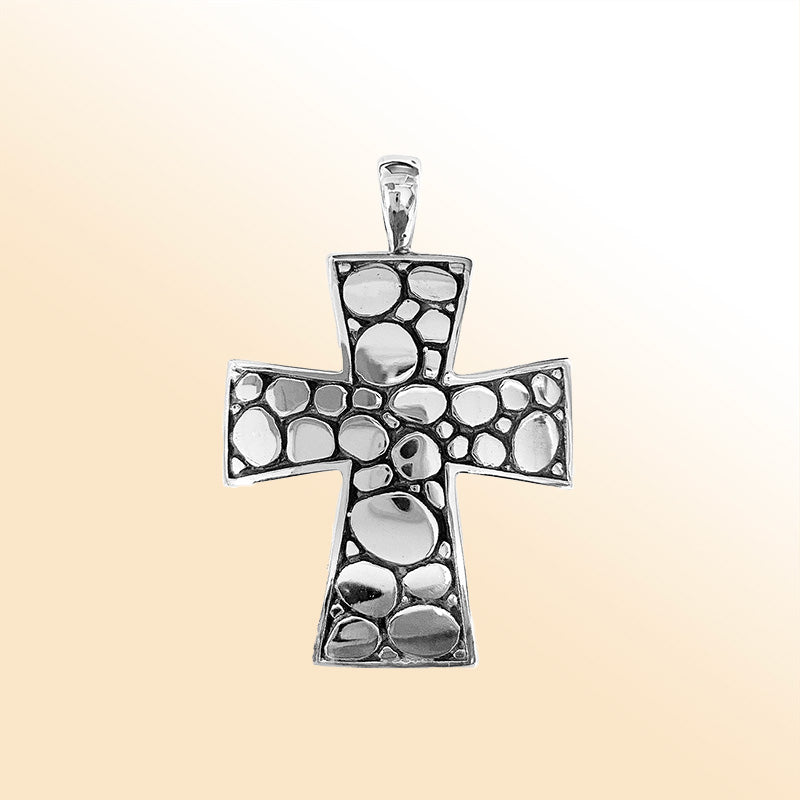 Artistic sterling silver cross pendant with polished pebble texture and oxidized Balinese handcrafted detailing.