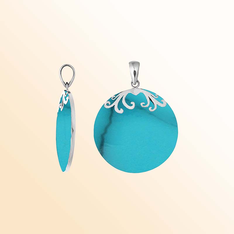 Elegant sterling silver circular pendant displaying luminous turquoise blue shell with subtle dark veins, delicate silver floral scroll accents crowning the upper edge, and a beautifully polished hanging bail.