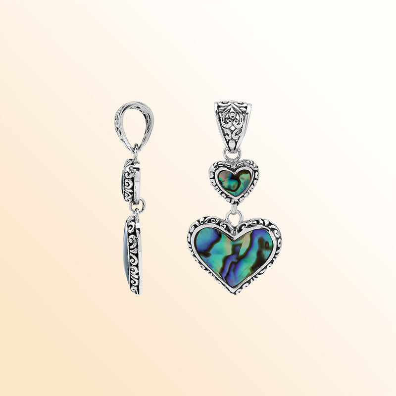 Artisan sterling silver pendant featuring Abalone Shell double hearts with Balinese accents.