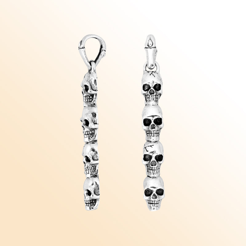 Artisan sterling silver vertical skull pendant with carved detailing and polished finish.